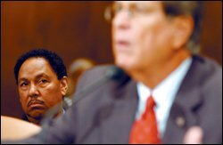 Assistant Secretary of Education Henry L. Johnson, left, listens as Sen. Trent Loft, R-Miss., addresses a Senate subcommittee last week on hurricane aid to schools.