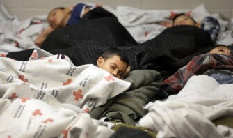 Child detainees sleep in a holding cell at the U.S. Customs and Border Protection processing facility in Brownsville, Texas. The detainees sleep on the floor, and there is a toilet in the corner of each cell.