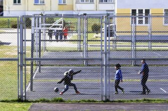 School children play football at their school sports facilities in Minsk, Belarus, Monday, April 20, 2020. Schools reopened Monday in Belarus following an extended spring break, but authorities allowed parents to keep their children at home even though the country specifically steered clear of closures and restrictions on public movement during the coronavirus pandemic.