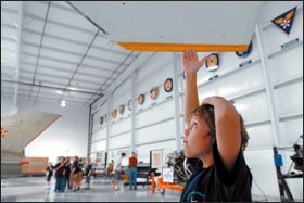 Austin Clark, 12, reaches toward an airplane wing at an aviation camp in Mesa, Ariz. The school district there is working with the Boeing Co. in the kind of partnership to improve math and science instruction that more companies are pursuing.
