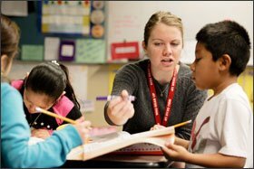 Teacher Jane Froese helps 1st grader Govanny Ramierz with a math assignment. Ms. Froese teaches two math classes in the morning, and Spanish literacy in the afternoon.