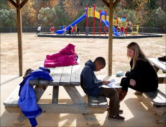 Jaclyn Midgette, helps Trell Chalmers, 10, with his homework while others play at recess. Midgette, a 4th grade reading and social studies teacher at Bullock Elementary School in Sanford, N.C., was part of the pilot group who took the new edTPA, a performance-based licensure test, when she was in school at East Carolina University.