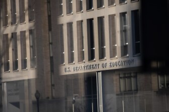 The U.S. Department of Education seen through layers of glass, in Washington, D.C., on Feb. 21, 2021.