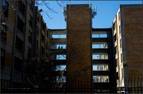 At left, residents walk between buildings at Potomac Gardens. Massive public-housing complexes like this one, which has 352 units, have fallen out of favor among federal and local housing agencies.