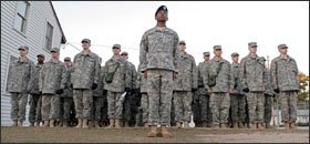 Sgt. 1st Class Kester Dozier, center, leads a platoon of fresh graduates of the Army Preparatory School. Civilian educators have visited the school to learn from its success at helping Army recruits quickly earn a General Educational Development credential, or GED.