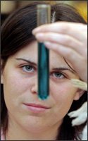 Sara Seale, 17, examines a test tube during a hands-on experiment at Huntsville High School in Alabama last month. The state of Alabama has taken several steps, with support from the business community, to try to improve math and science education.