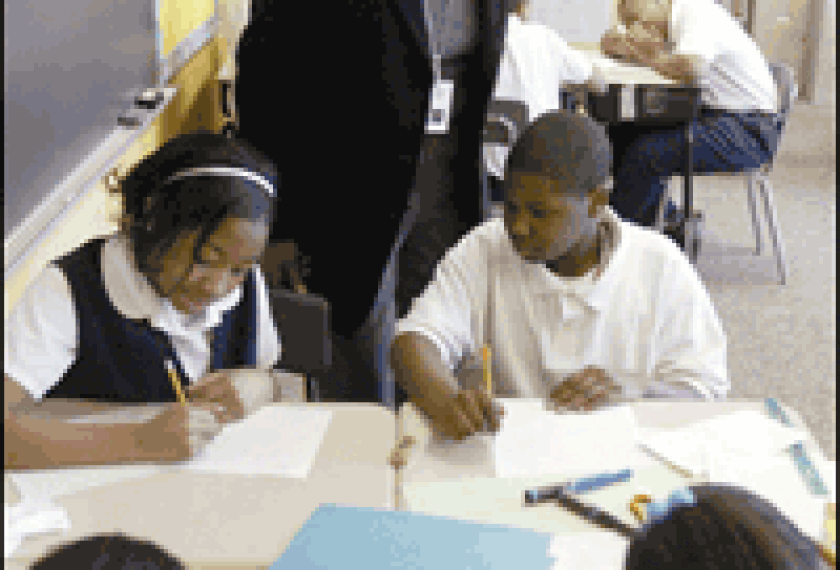 State education consultant Diana Wilson checks in on her voucher students at St. Francis School in Cleveland on March 15.
