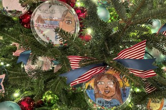 The self-portraits of students hang from a Christmas tree in the White House, including one from Leona Barlese (left), a 5th grader at Natchez Elementary School on the Pyramid Lake Paiute Reservation in Nevada.