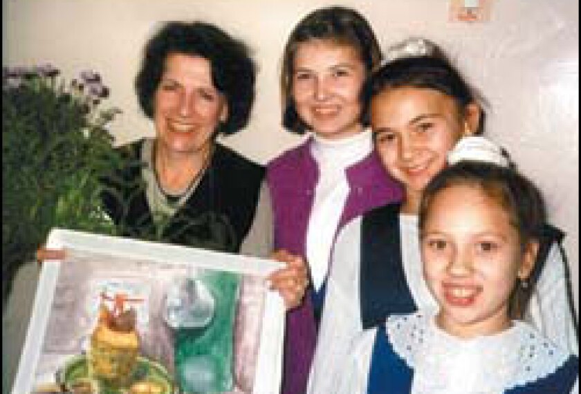 Teacher Jana Sackman Eaton displays a student's artwork in Togliatti, Russia.