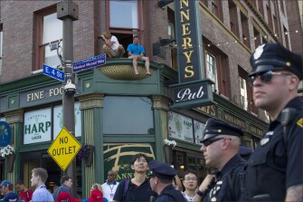 Police and the curious monitor the street scene in Cleveland on Tuesday during the Republican National Convention.