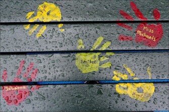 Painted hand prints with names of teachers and students decorate a playground bench at the new Sandy Hook Elementary School. The names are not those of people killed in the 2012 massacre at the old school.