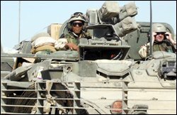 Connecticut principal Donald J. Slater, left, rides a Stryker tank near his base in Balad, Iraq.