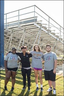 From left: Tonnekqua Dixon, 17, Richard Perez, 14, Zoe White, 14, and Austin Overstreet, 16, pose together last month after a field day event at Greene Central High School in Snow Hill, N.C. The students are part of Peer Group Connection, a youth mentoring program that pairs new 9th graders with 11th and 12th graders who help guide them through the transition to high school.