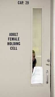 A young detainee looks through the door of a holding cell at a U.S. Customs and Border Protection processing facility in Brownsville, Texas.