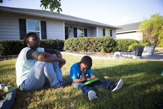 Franiqueka Fortune and her son, Xavier, 3, on the lawn of their Houston home. Fortune evacuated from New Orleans as a 15-year-old high school junior just before Hurricane Katrina struck.