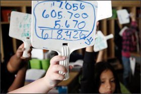 Donna Young's students display their answers to the math problem.