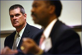 Jimmy Cunningham, left, the superintendent of the Danville, Ark., schools, listens to National School Boards Association lobbyist Reginald M. Felton at the National Rural Education Association's legislative forum on March 26.