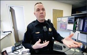 Sgt. Jason Halifax, of the Des Moines Police Department, in Des Moines, Iowa, shows a body camera used by one of the agency's school resource officers.
