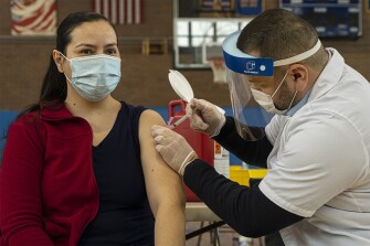 Teacher Lizbeth Osuna from Cooper Elementary receives the Moderna vaccine at a CPS vaccination site at Roberto Clemente High School in Chicago, Ill., Thursday, Feb. 11, 2021.