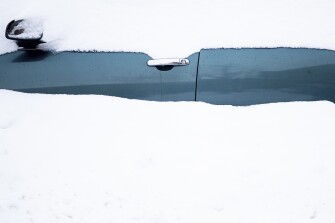 A car sits in a snowdrift Friday, Nov. 18, 2022, in Buffalo, N.Y. A dangerous lake-effect snowstorm paralyzed parts of western and northern New York, with nearly 2 feet of snow already on the ground in some places and possibly much more on the way.