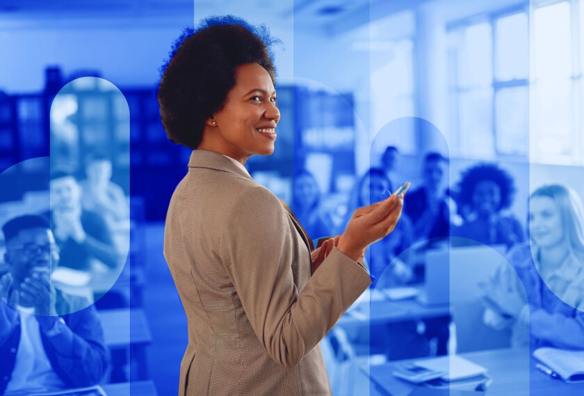 Happy African American teacher receives applause from her students while lecturing them in the classroom.