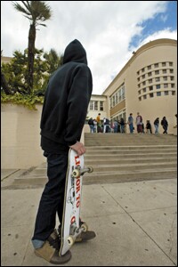 States hope to do a better job tracking students who finish high school. They also want to get more accurate counts of those who drop out, such as this boy, who waits for friends outside his former campus, Hollywood High School in Los Angeles, earlier this year.