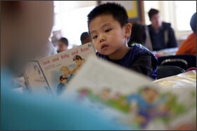 First grader Mason Chu, 6, reads while his classmates have reading conferences at P.S. 173 Fresh Meadows School in New York City.