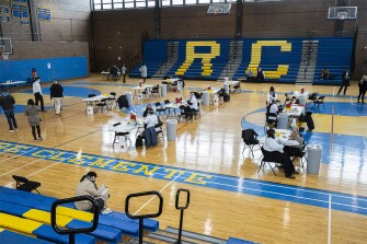Tables for patients to get the Moderna vaccine are attended by Walgreen's Pharmacist at a CPS vaccination site at Roberto Clemente High School, 1147 N Western Ave in Ukrainian Village, Thursday, Feb. 11, 2021.