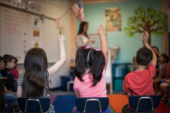 Assistant Teacher Kimberly Fisher talks with a student preparing for kindergarten. Children in the KITS program attend multiple sessions, where they learn the so-called soft skills they will need to be successful when they start school in September.