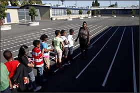 Cicely Day lines up her 3rd grade class at PLACE at Prescott School in Oakland. She became a teacher after studying fashion design and working in child care.