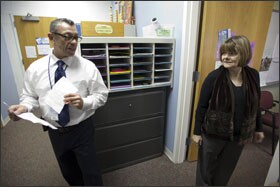 Andrew Tellez, at left, the assistant principal at Finkl, talks with Susan Jensen in the office. Ms. Jensen, a former principal of the school, now works with Strategic Learning Initiatives.