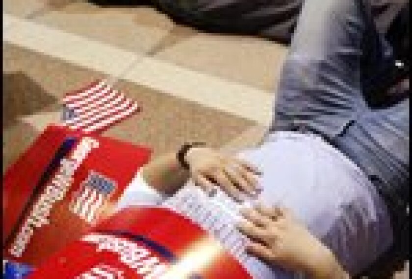 WASHINGTON, United States: Supporters of US President George W. Bush sleep on the floor of the Ronald Reagan Building in Washington at the Republican National Committee election night party 03 November 2004 as the presidential vote was thrown into turmoil as Democratic challenger John Kerry refused to surrender to Bush. The races in the state of Ohio and New Mexico have been called too close to call as broken machines and fatigue halted counting in Iowa.