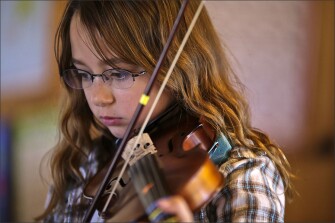 Corinne practices her violin. She takes violin lessons in Wheatland, the nearest town.