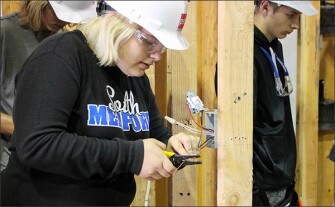 Sydney Hathaway, another Benson Tech student, wires a light switch during her sophomore year with the PACE program.