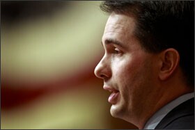 Wisconsin Gov. Scott Walker speaks to a joint session of the state legislature in Madison on Feb. 1. The governor is calling for public employees to pay about 5 percent of their salaries toward their pensions and to pay 12 percent of their health-insurance premiums.
