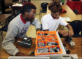 Sophomore Jaylon Lucas, left, and freshman Joseph Williams assemble a Boe-Bot robot while attending a cyber literacy class at Plain Dealing High School in Louisiana.