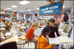 Mentor Pamela Scherzer, left, and Principal Mary Brandt visit a 3rd grade classroom at Winnebago Elementary School in Illinois.