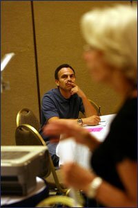 LEARNING THE WAY: Gerardo Cortes-Lopez, a teacher, looks on as Barbara Terrel speaks during the training session for new teachers last month.