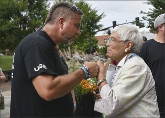 Blacksburg resident Phyllis Albritton, right, speaks with Bryan Melchior, co-owner of Utah Gun Exchange, an online gun sales portal, following the road to change rally. Melchior has traveled across the country in a counter-protest to the Road to Change tour.