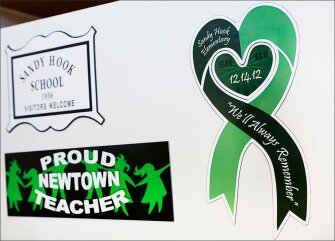 A sign at the new Sandy Hook Elementary School pays tribute to those killed after a gunman entered the old school in December 2012, and killed 20 students and six educators. The $50 million, 86,800-square-foot building opens later month.