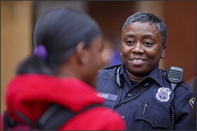 School resource officer Willette Barr talks with senior Autumn Koins during lunch at Grady High. Both Barr and Hammond previously worked as county sheriff’s deputies before being hired by the Atlanta district.