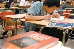 Pao Yang, a 10th grader, works on homework in a transitional science class for English-language learners at Humboldt Senior High School.