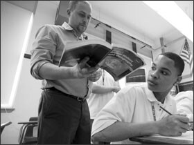 History teacher Andy Jarmoc stops by Alamin’s desk.