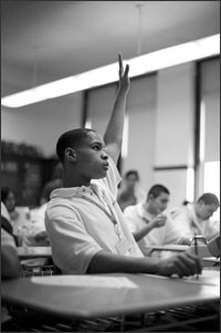 Alamin raises his hand to answer a question in April Burmeister’s math class. With his teachers’ help, the student decided he needed to sit farther away from peers who could distract him to try to bring up his grades.