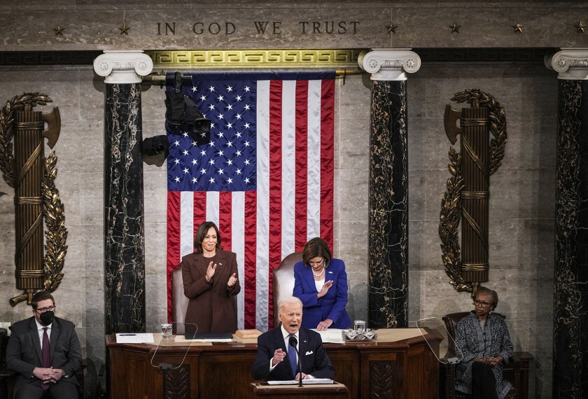 President Joe Biden delivers his first State of the Union address to a joint session of Congress at the Capitol, Tuesday, March 1, 2022, in Washington as Vice President Kamala Harris applauds and House speaker Nancy Pelosi of Calif., looks on.