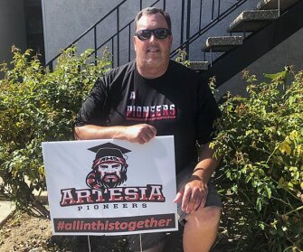 Will Napier, a special education teacher at Artesia High School, southeast of Los Angeles, appreciates the things his school has done to boost teachers' morale, like passing out these lawn signs. But he is still struggling to feel good about teaching remotely.