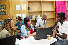 From left to right, English/language arts teachers June Eccleston, Elizabeth Robinson, Deborah Swigart, and Lance Shields sit with Kellee Iverson, a personalized learning coach, to finalize lesson plans during a “What I Need” day at Luella Middle School.