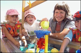 Jane Davidson, Wales' minister of education, plays with pupils at the Early Years Center in Cornelly. As part of the new Welsh policies, youngsters' school days will be play-filled, while older students will do projects and research.