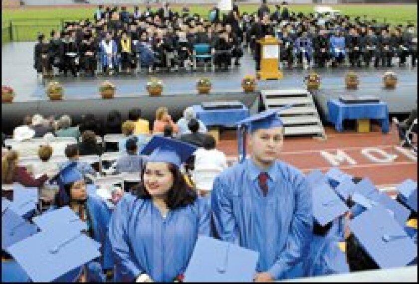 A few of the graduates of Santa Monica College turn their backs in protest as Gov. Arnold Schwarzenegger, at lectern, delivers a commencement address on June 14.