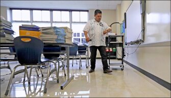 HISD Superintendent Richard Carranza walks through a classroom damaged by floodwaters at A.G. Hilliard Elementary School in the aftermath of Hurricane Harvey on Sept. 2, in Houston.